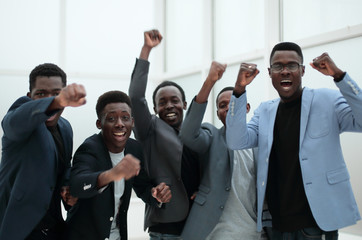 happy jubilant business team standing in office lobby