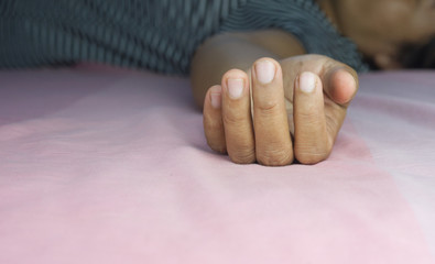 Close up of hand Unconscious on bedroom.