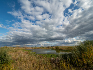 Scrap and left overs of fishing farm in Chernobyl Exclusion Zone, Ukraine. Dramatic sky over the lake.