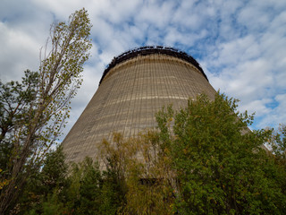 Unfinished cooling tower in Chernobyl zone at afternoon, fall season, abandoned building of Chernobyl nuclear power plant, Ukraine