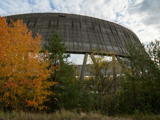 Unfinished cooling tower in Chernobyl zone at afternoon, fall season, abandoned building of Chernobyl nuclear power plant, Ukraine