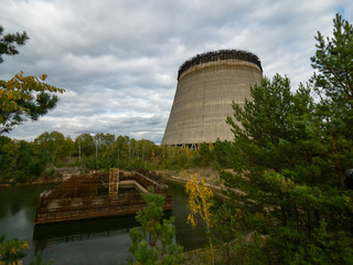 Unfinished cooling tower in Chernobyl zone at afternoon, fall season, abandoned building of...