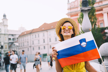 Woman tourist with slovenian flag in Ljubljana, Slovenia, Europe.