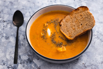 plant-based food, homemade vegan carrot and cauliflower soup with sourdough bread