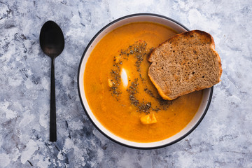 plant-based food, homemade vegan carrot and cauliflower soup with sourdough bread