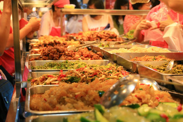 People buying their dinner in a bento restaurant