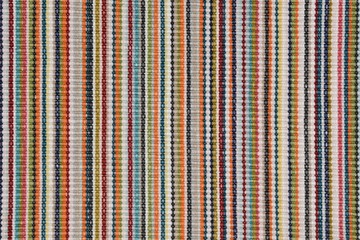 Colorful textured background of a striped rug