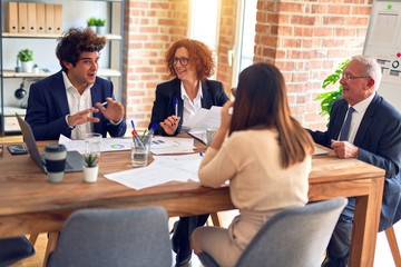 Group of business workers smiling happy and confident. Speaking with smile on face working together at the office.