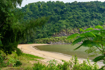 Fototapeta na wymiar beautiful view of a deserted beach surrounded by a jungle. Cat Ba, Vietnam