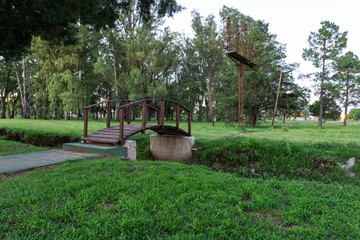 Scene view of wooden bridge on a green park in Huinca Renancó, Córdoba, Argentina