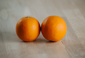 Two fresh orange on the table.