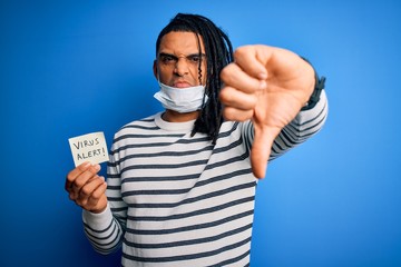 African american man with dreadlocks wearing medical mask holding virus alert reminder with angry...
