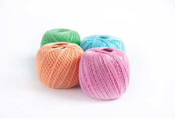 Children's hand takes an egg from a straw nest on a white background, where several more eggs lie