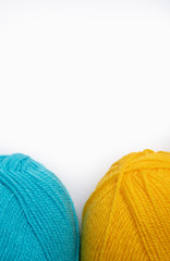 two skeins of wool thread isolate on white, blue and yellow, copy space upstairs