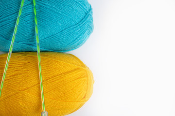 two skeins of wool thread isolate on white, blue and yellow, copy space on right side