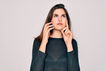 Young beautiful woman having a conversation talking on smartphone ove isolated background serious...