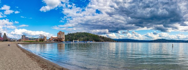 Coeur d'Alene beach with resort and cloudy sky background