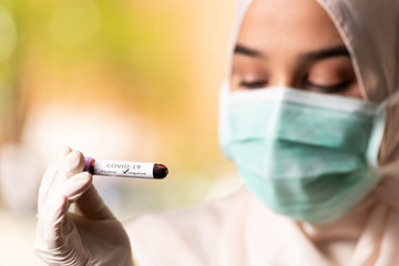 Muslim Woman Doctor Holding Blood Test Covid-19