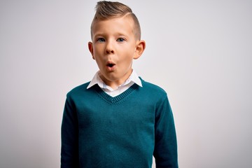 Young little caucasian kid with blue eyes standing wearing elegant clothes over isolated background afraid and shocked with surprise expression, fear and excited face.