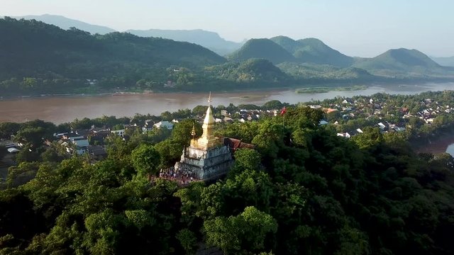 Lunag Prabang, Laos, Aerial View of Buddhist Temple. Mekong River and Scenic Landscape on Golden Hour Sunlight