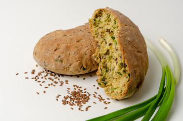 Delicious freshly baked Australian Damper Loaf with onion and linen seeds on white background