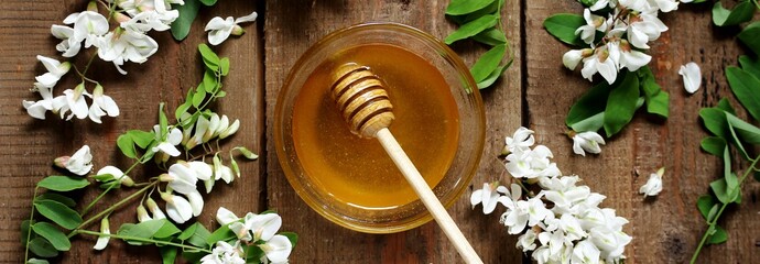 honey acacia white on the background of an old plaque and acacia flowers. view from above. concept of rural organic food. view from above. copy space. Flatlay