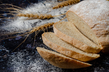 Homemade bread loaf on rustic dark background