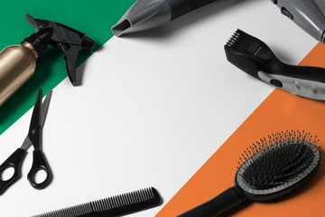 Ireland flag with hair cutting tools. Combs, scissors and hairdressing tools in a beauty salon...