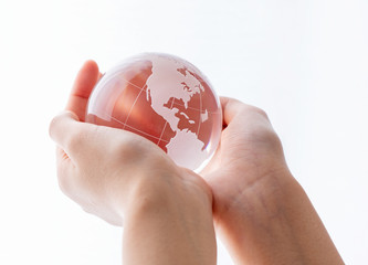 Female hand with glass globe. Peace and ecology