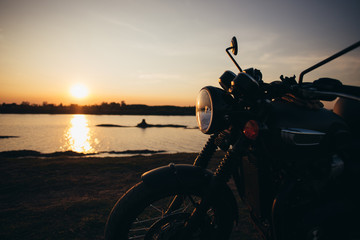 A motorcycle on the road with sunset light background