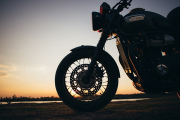A motorcycle on the road with sunset light background