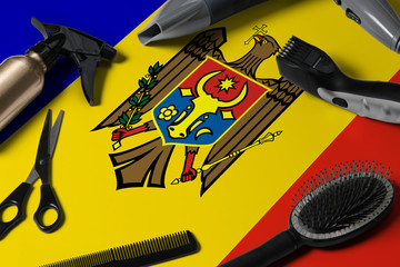 Moldova flag with hair cutting tools. Combs, scissors and hairdressing tools in a beauty salon desktop on a national wooden background.
