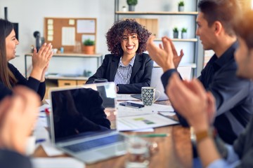 Group of business workers smiling happy and confident. Working together with smile on face applauding one of them at the office