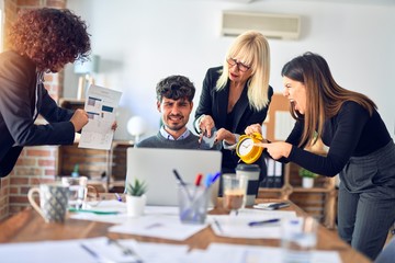 Group of business workers working together. Partners stressing one of them at the office