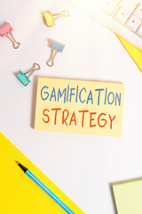 Conceptual hand writing showing Gamification Strategy. Concept meaning use Rewards for Motivation Integrate Game Mechanics Flat lay with pc keyboard and copy space for text messages