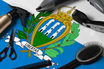 San Marino flag with hair cutting tools. Combs, scissors and hairdressing tools in a beauty salon desktop on a national wooden background.