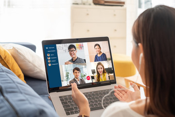 Young Asian businesswoman work at home and virtual video conference meeting with colleagues business people, online working, video call due to social distancing - obrazy, fototapety, plakaty
