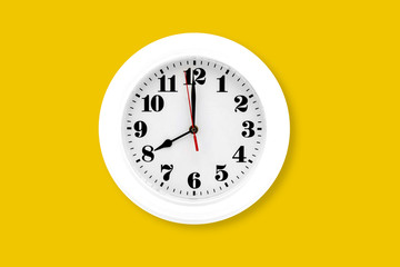Modern wall clock white isolated on yellow background, time and period, office timepiece and mockup with hour and minute, hour hand, object classic.