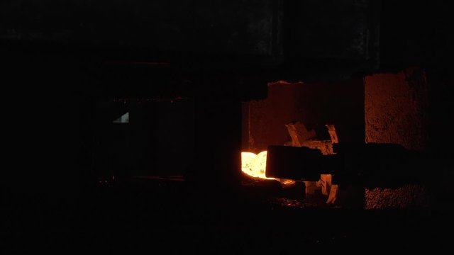 Red hot steel metal billets after molten steel casting, heavy metallurgy concept. Scene. Background of the blacksmith and metallurgical industry.