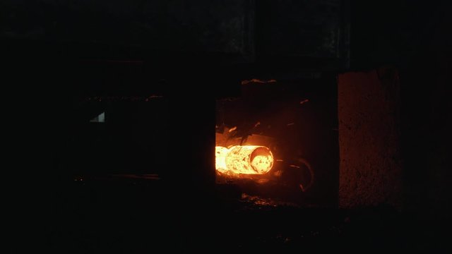 Red hot steel metal billets after molten steel casting, heavy metallurgy concept. Scene. Background of the blacksmith and metallurgical industry.