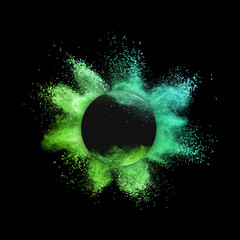 Decorative round frame with powder splash on a black background.