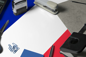 France flag with office clerk workplace background. National stationary concept with office tools.