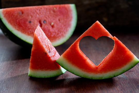 Watermelon cut into pieces, punched a hole into a heart shape.