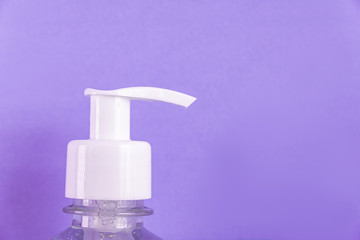 Container with alcohol gel on the light blue background