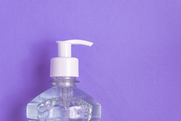 Container with alcohol gel on the light blue background