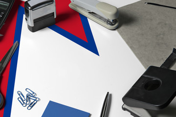 Nepal flag with office clerk workplace background. National stationary concept with office tools.