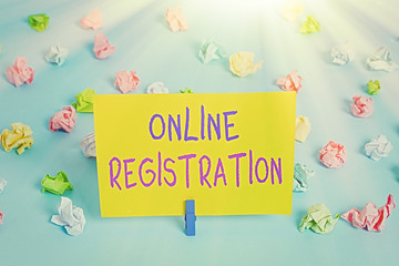Text sign showing Online Registration. Business photo text Process to Subscribe to Join an event club via Internet Colored crumpled papers empty reminder blue floor background clothespin