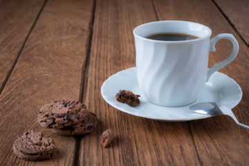 
Black coffee in a white coffee mug on a wooden table