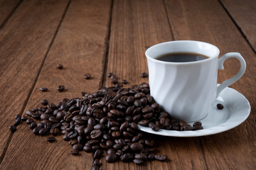 
Black coffee in a white coffee mug on a wooden table