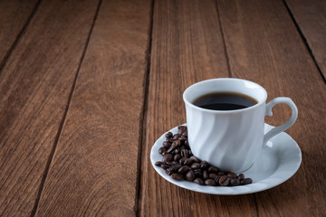 
Black coffee in a white coffee mug on a wooden table